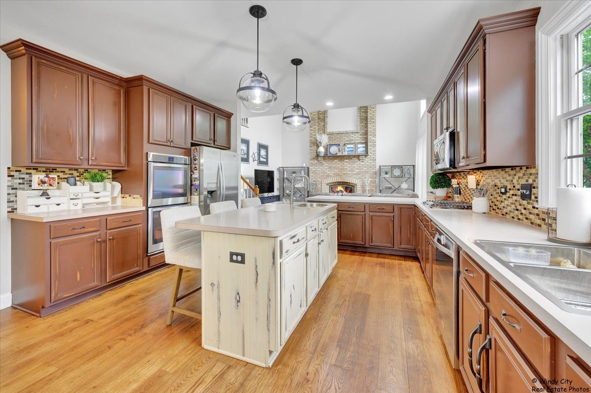1880 Crofton Drive Algonquin, IL 60102 - Photo 8 of 44 a kitchen with a sink stove cabinets and wooden floor