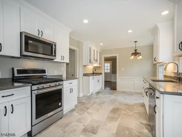 a kitchen with stainless steel appliances granite countertop a stove and a sink