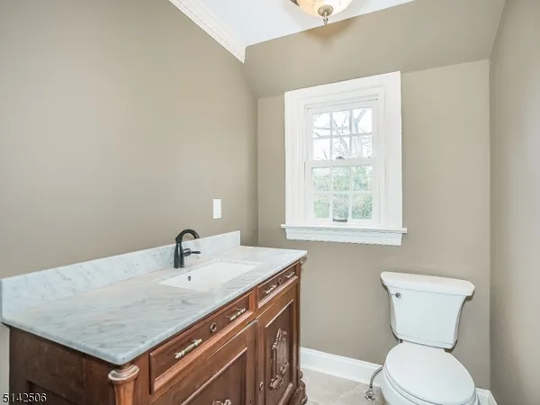 a bathroom with a toilet sink and window