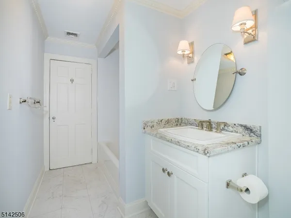 a bathroom with a sink vanity and a mirror
