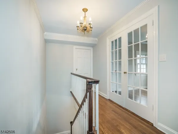 a view of a room with wooden floor and staircase