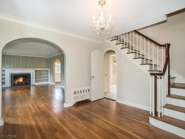 a view of a livingroom with wooden floor and staircase
