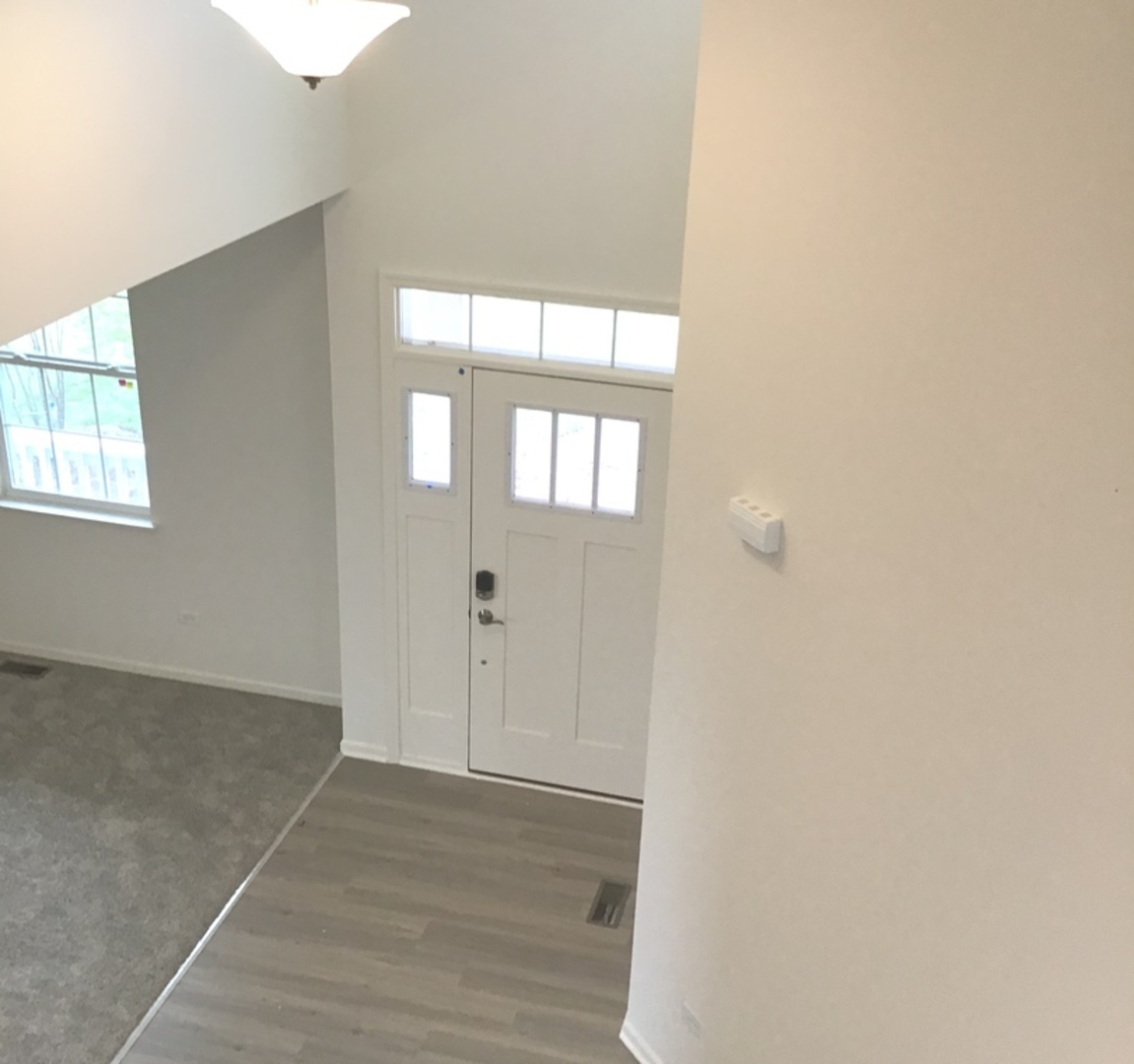 3118 Patterson Road Montgomery, IL 60538 - Photo 21 of 23 an empty room with wooden floor and windows