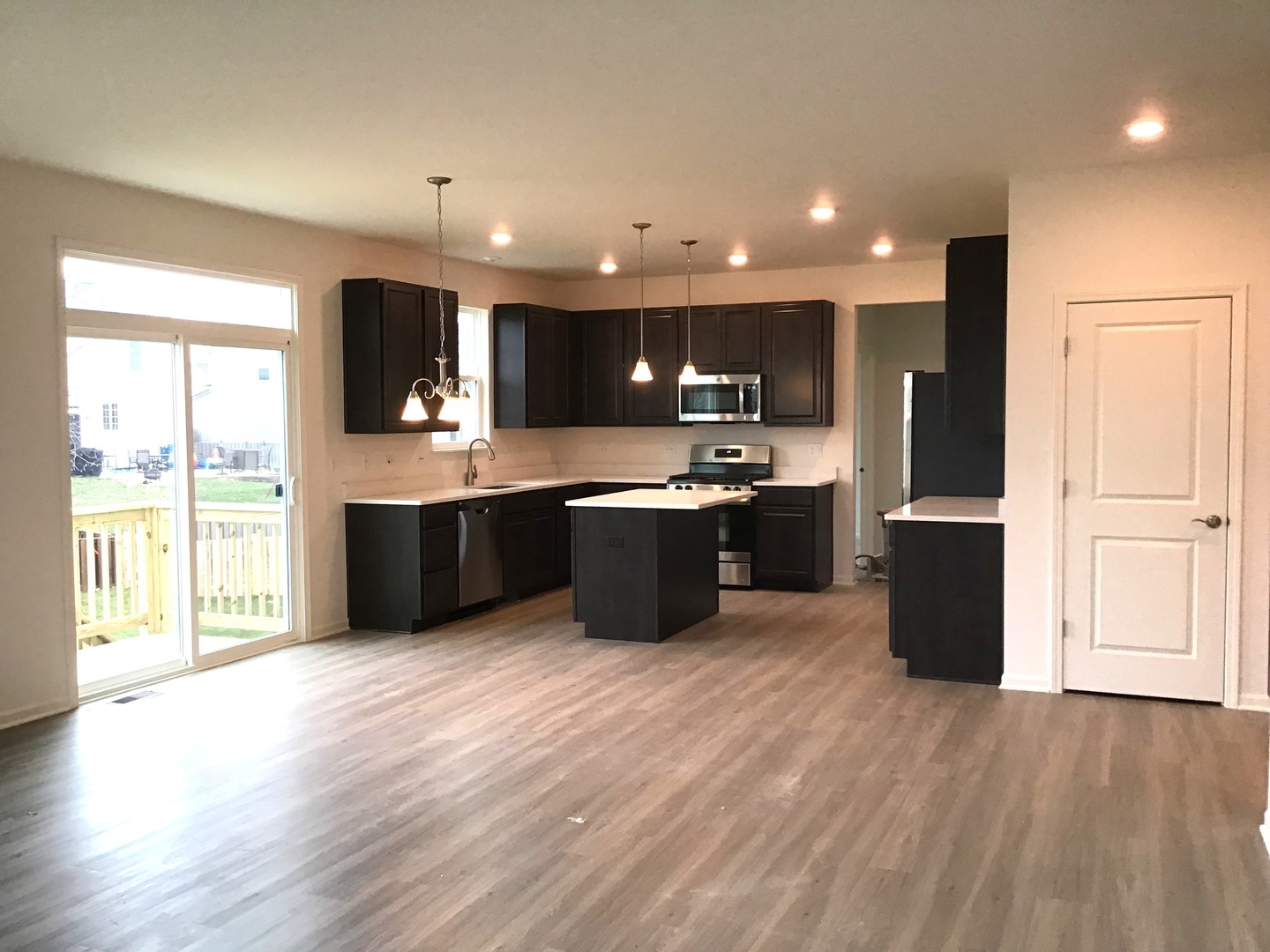 3118 Patterson Road Montgomery, IL 60538 - Photo 7 of 23 a kitchen with stainless steel appliances granite countertop a sink a stove and a refrigerator