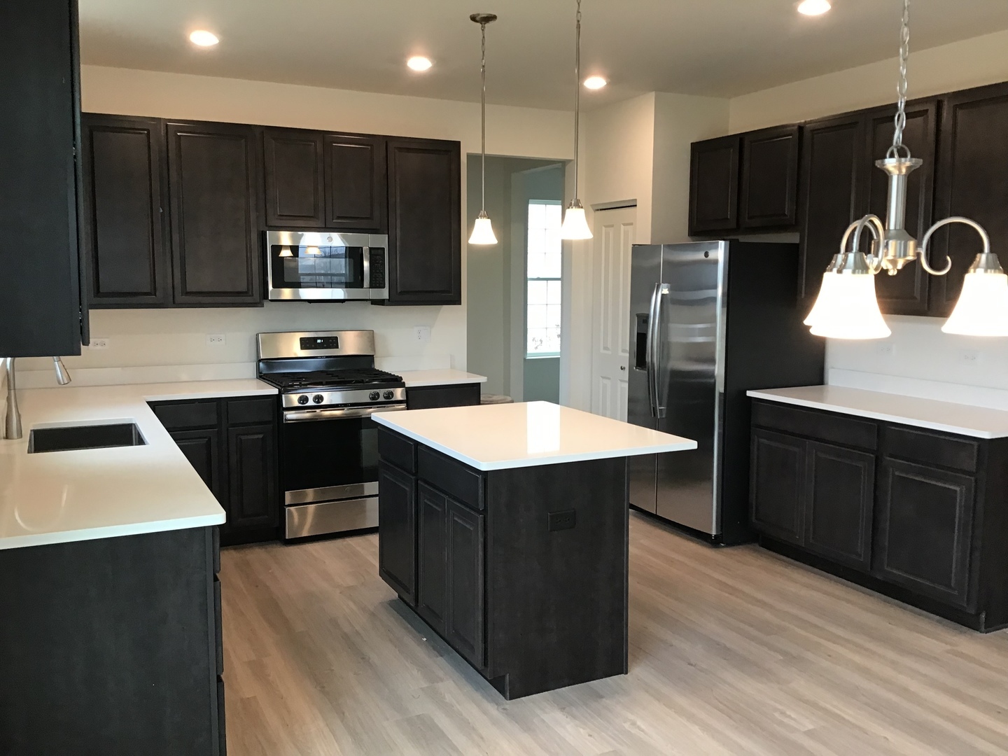 3118 Patterson Road Montgomery, IL 60538 - Photo 8 of 23 a kitchen with stainless steel appliances granite countertop a refrigerator a sink a stove a microwave and cabinets