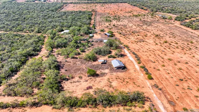 an aerial view of a house with a yard and lake view