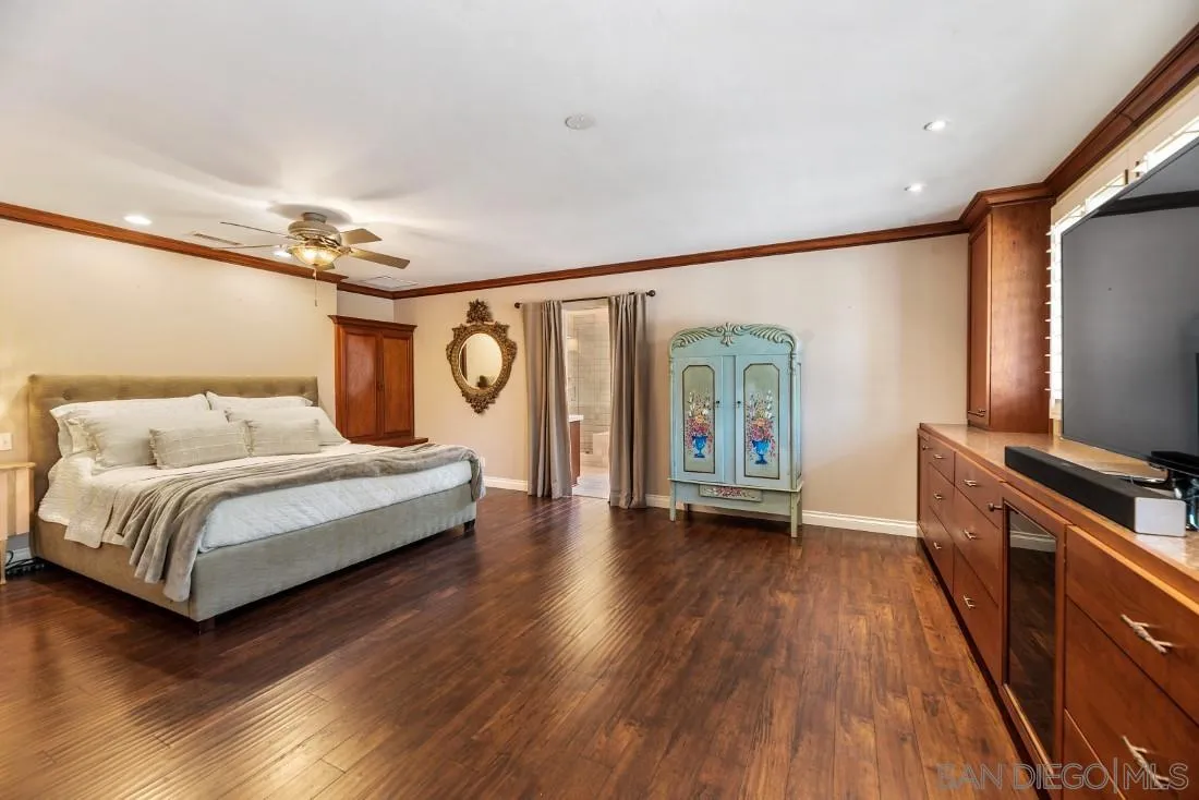 14725 Espola Road Poway, CA 92064 - Photo 18 of 50 a bedroom with a bed and a flat screen tv