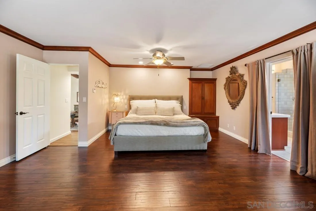 14725 Espola Road Poway, CA 92064 - Photo 19 of 50 a spacious bedroom with a bed and wooden floor