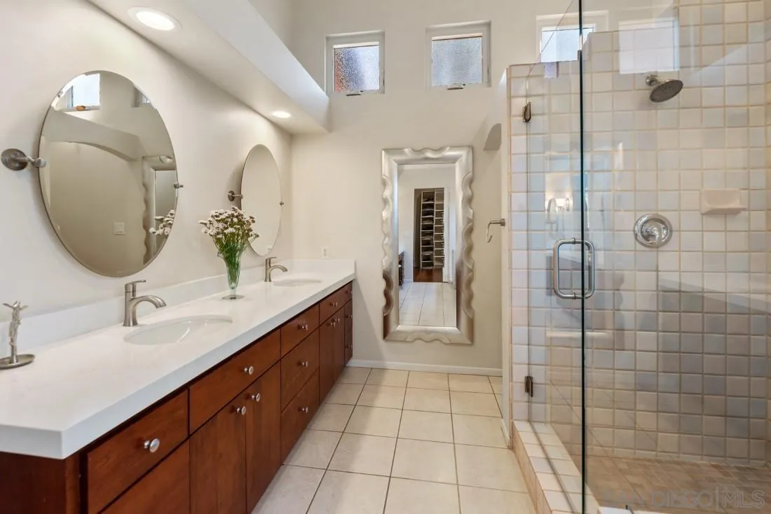14725 Espola Road Poway, CA 92064 - Photo 21 of 50 a bathroom with a double vanity sink mirror and shower