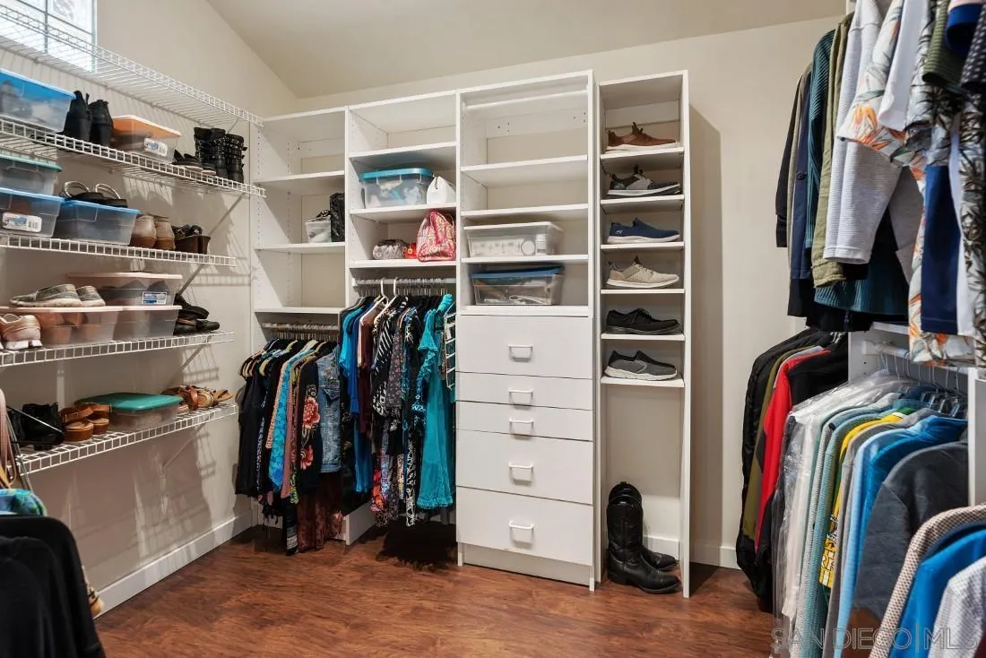 14725 Espola Road Poway, CA 92064 - Photo 22 of 50 a view of walk in closet with clothes and shoes