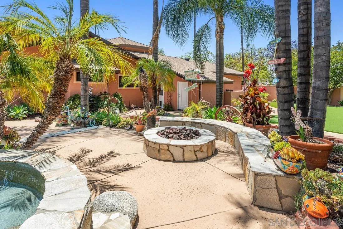 14725 Espola Road Poway, CA 92064 - Photo 31 of 50 a view of a backyard with fountain plants and palm trees