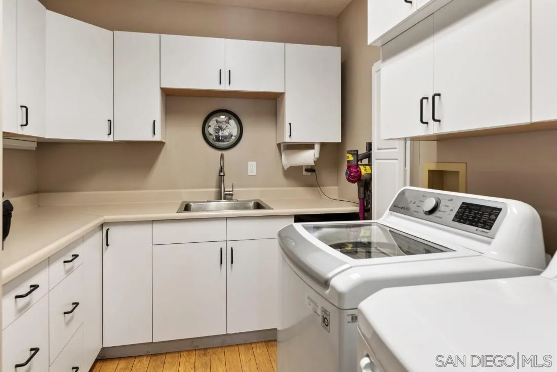 14725 Espola Road Poway, CA 92064 - Photo 50 of 50 a kitchen with a sink cabinets and utility