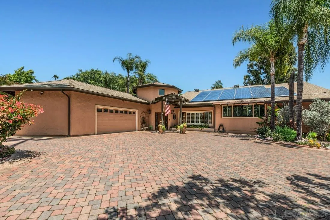 14725 Espola Road Poway, CA 92064 - Photo 6 of 50 a front view of a house with a yard and garage