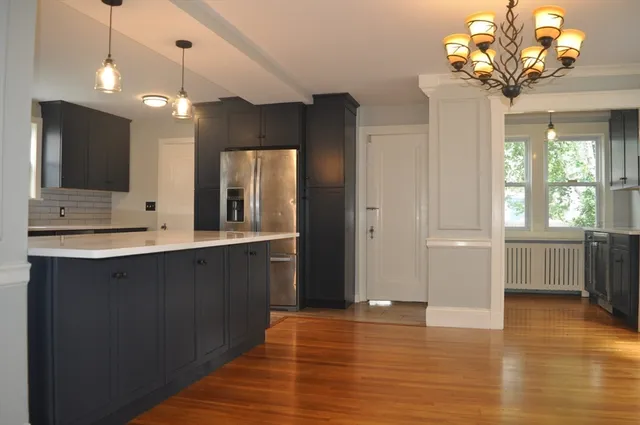 a view of a kitchen with a sink wooden floor and windows