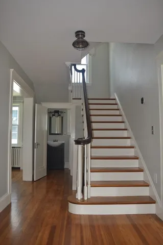 a view of entryway and hall with wooden floor