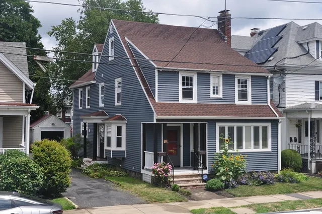 a front view of a house with garden and porch