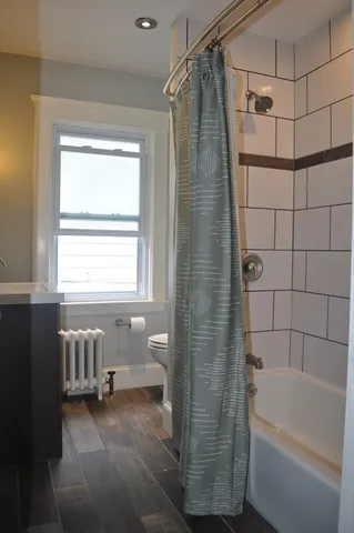a bathroom with a bathtub and a shower