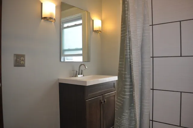 a view of a bathroom with a sink and a mirror