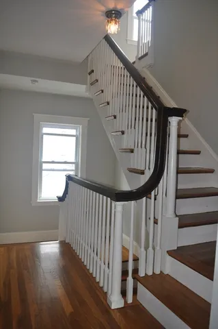 a view of an entryway with wooden floor and stairs