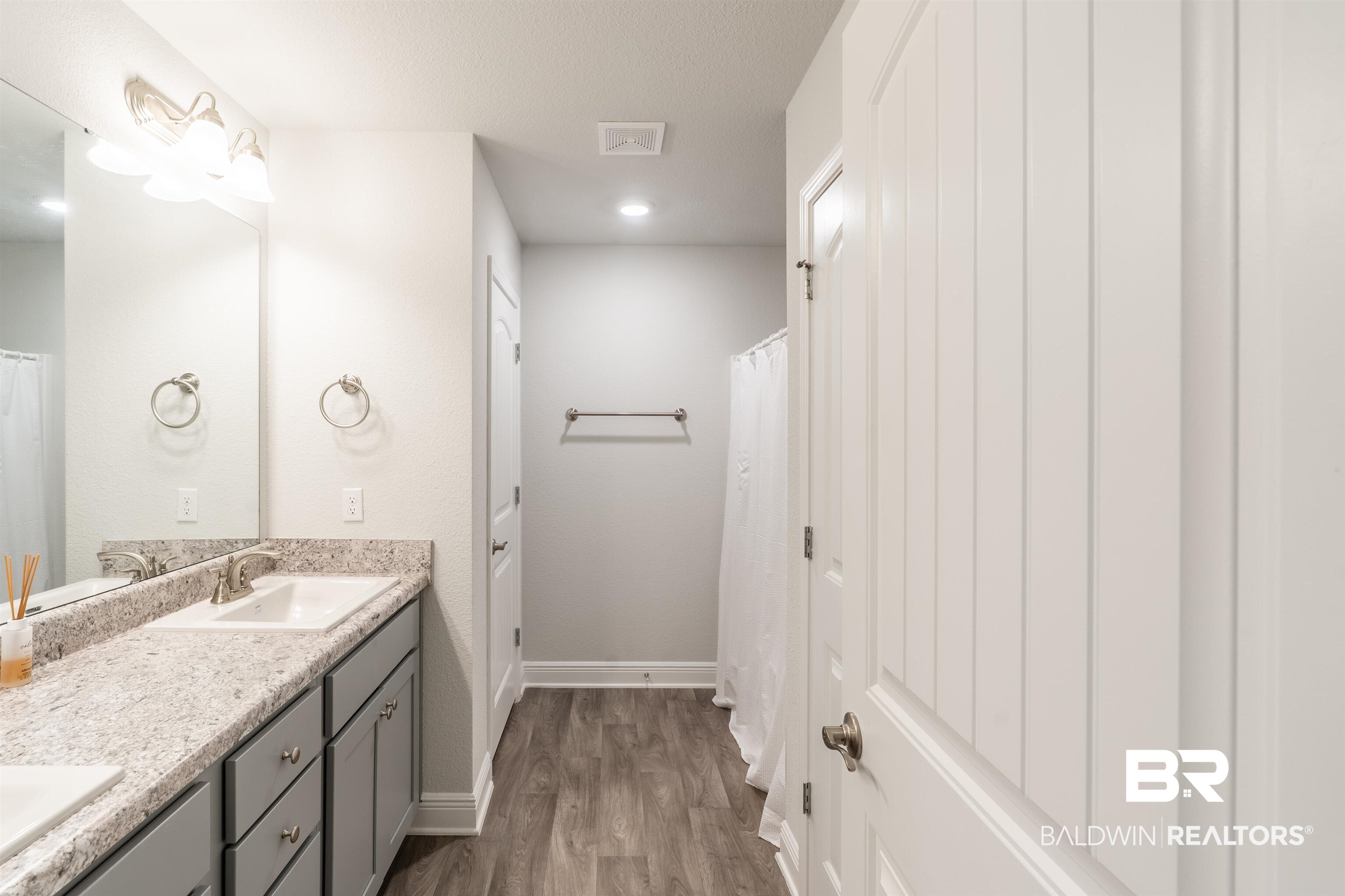 1906 Stonepine Drive South Semmes, AL 36575 - Photo 22 of 30 Full bath with double vanity, dark wood finished floors, and curtained shower