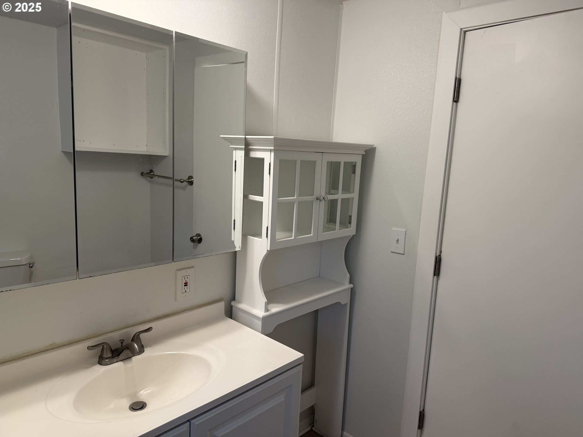 7409 Southeast 82nd Avenue, Unit 4 Portland, OR 97266 - Photo 4 of 15 a bathroom with a sink and a mirror