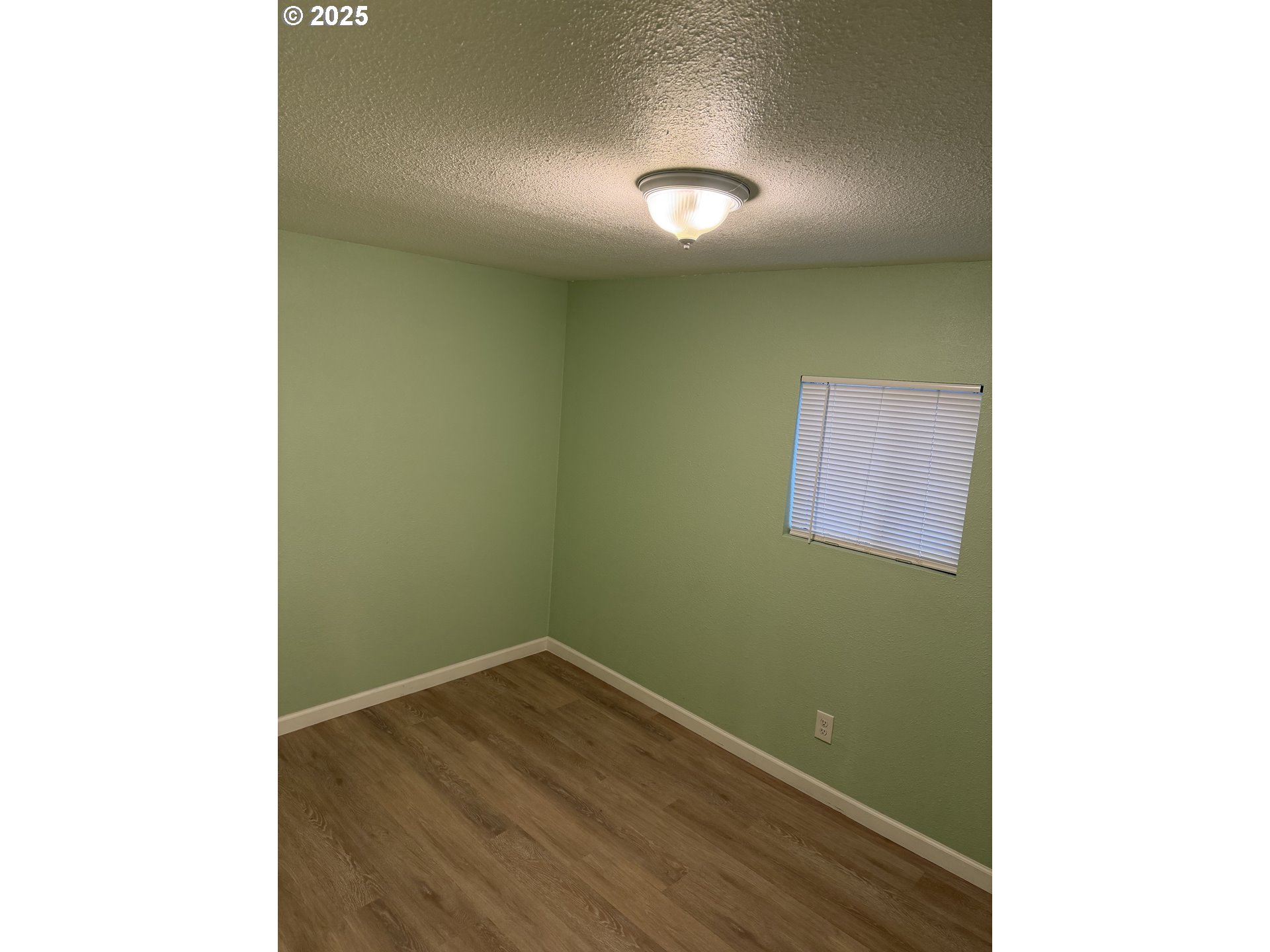 7409 Southeast 82nd Avenue, Unit 4 Portland, OR 97266 - Photo 7 of 15 a view of a room with wooden floor and brick walls