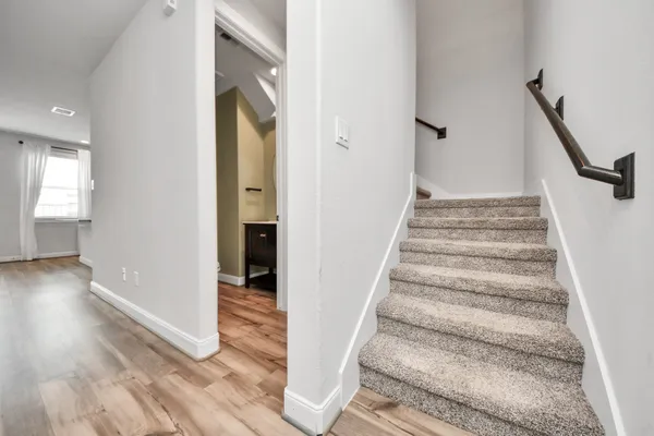 a view of an entryway with wooden floor and stairs