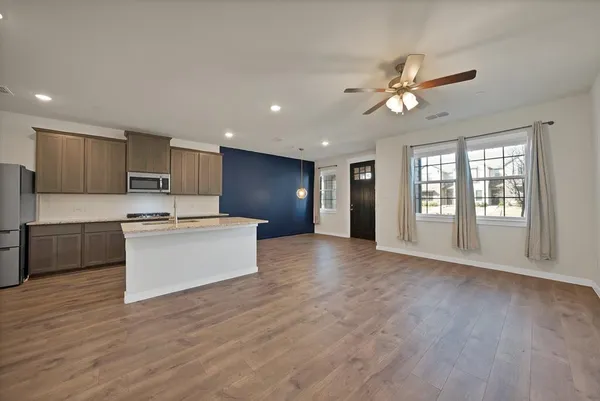 a view of kitchen with cabinets and wooden floor