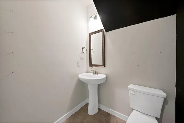 a bathroom with a sink mirror and toilet