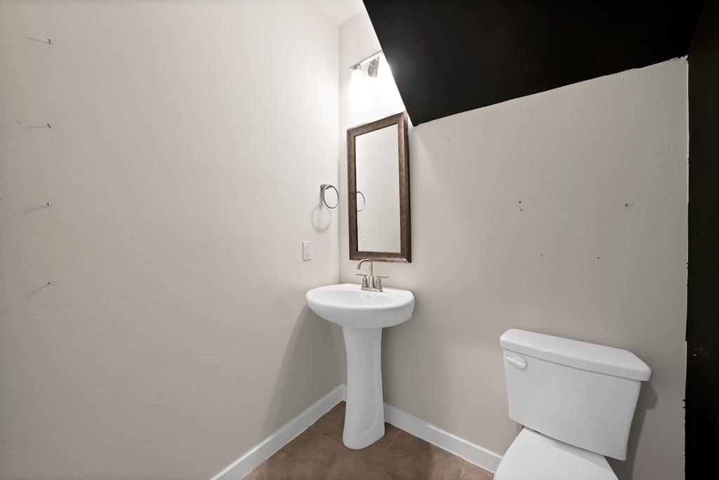 6610 Baritone Court Sachse, TX 75048 - Photo 13 of 30 a bathroom with a sink mirror and toilet