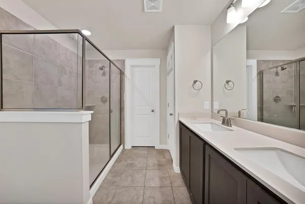 a bathroom with a double vanity sink and mirror