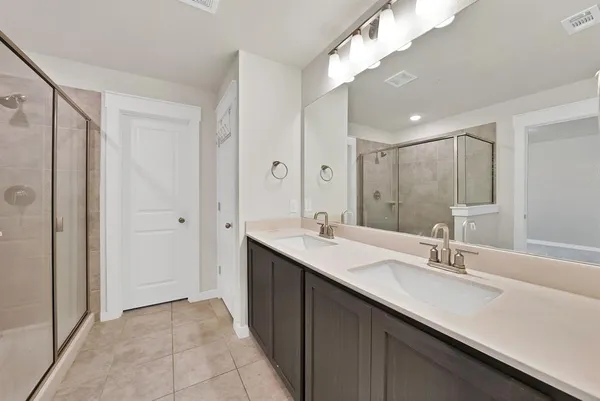 a bathroom with a double vanity sink and a mirror