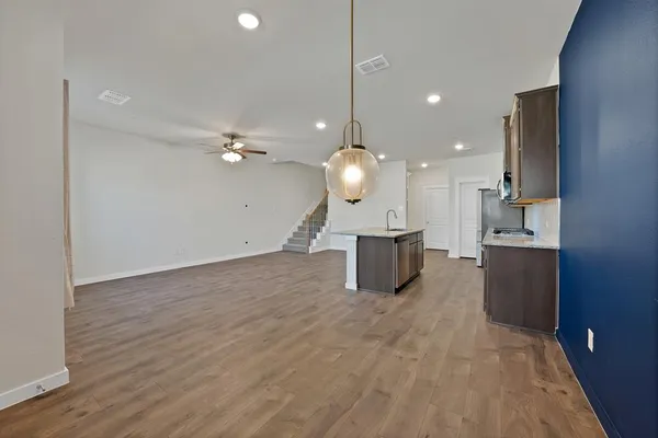 a open kitchen view and a wooden floor