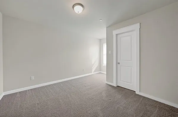 an empty room with closet area