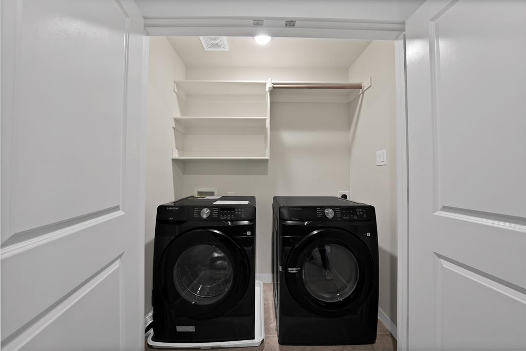 6610 Baritone Court Sachse, TX 75048 - Photo 26 of 30 a utility room with closet dryer and washer
