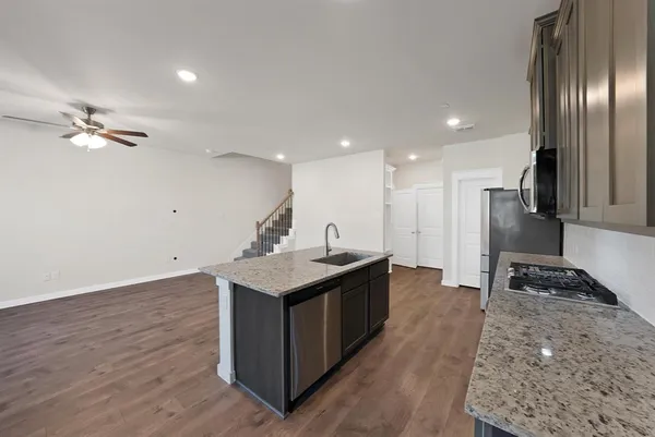 a kitchen with a stove a refrigerator and a sink