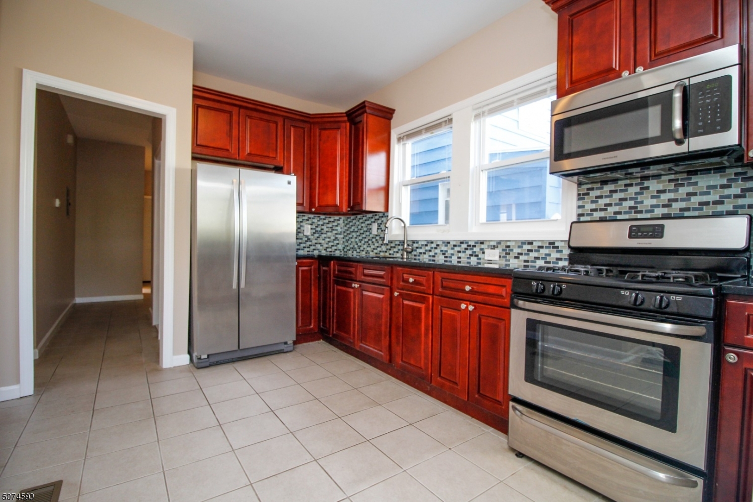 52 New Street, Unit A Montclair, NJ 07042 - Photo 1 of 18 a kitchen with stainless steel appliances granite countertop a stove microwave and refrigerator