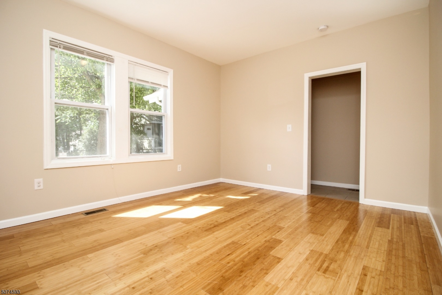 52 New Street, Unit A Montclair, NJ 07042 - Photo 11 of 18 a view of an empty room with wooden floor and a window