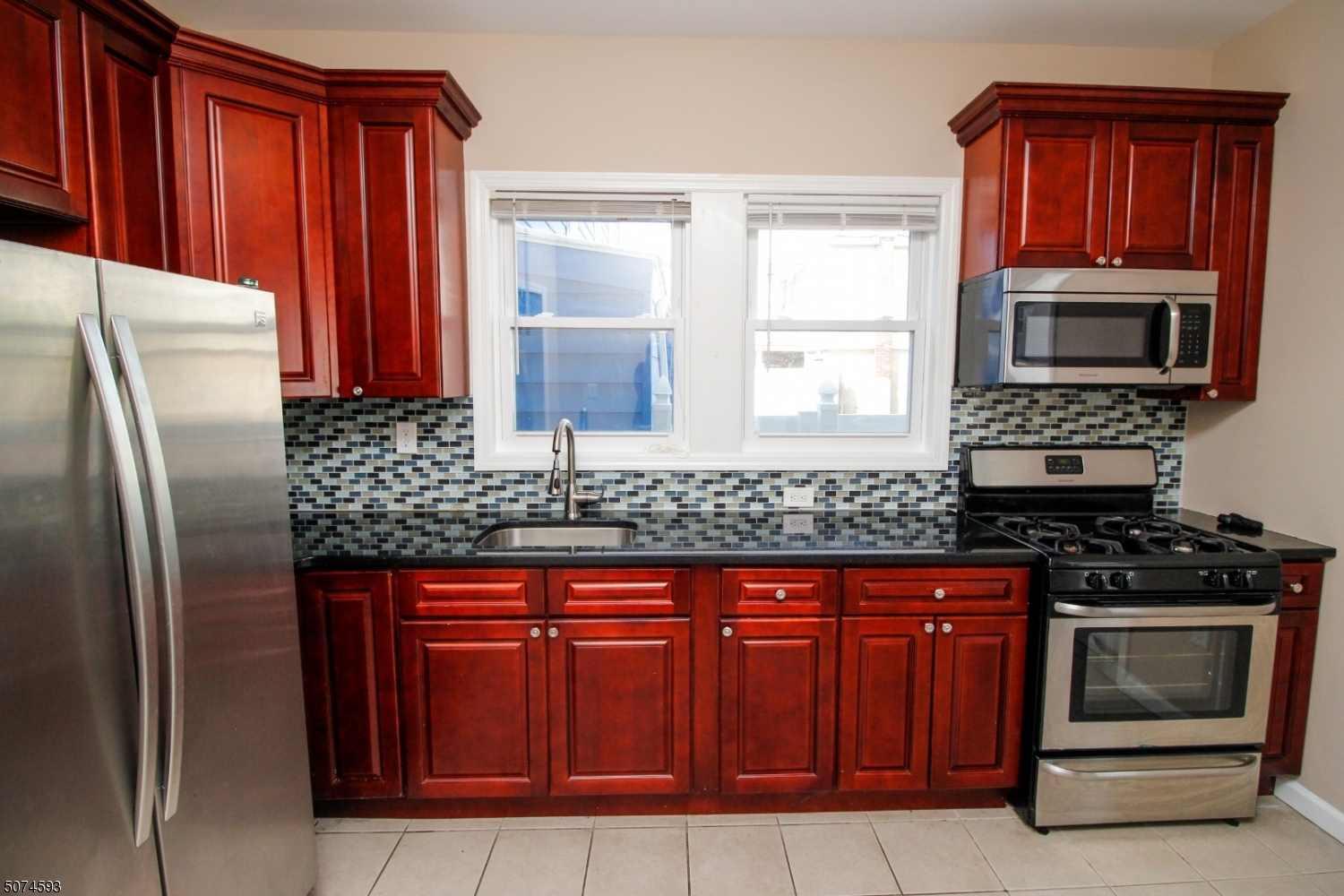 52 New Street, Unit A Montclair, NJ 07042 - Photo 2 of 18 a kitchen with granite countertop a stove top oven microwave and refrigerator
