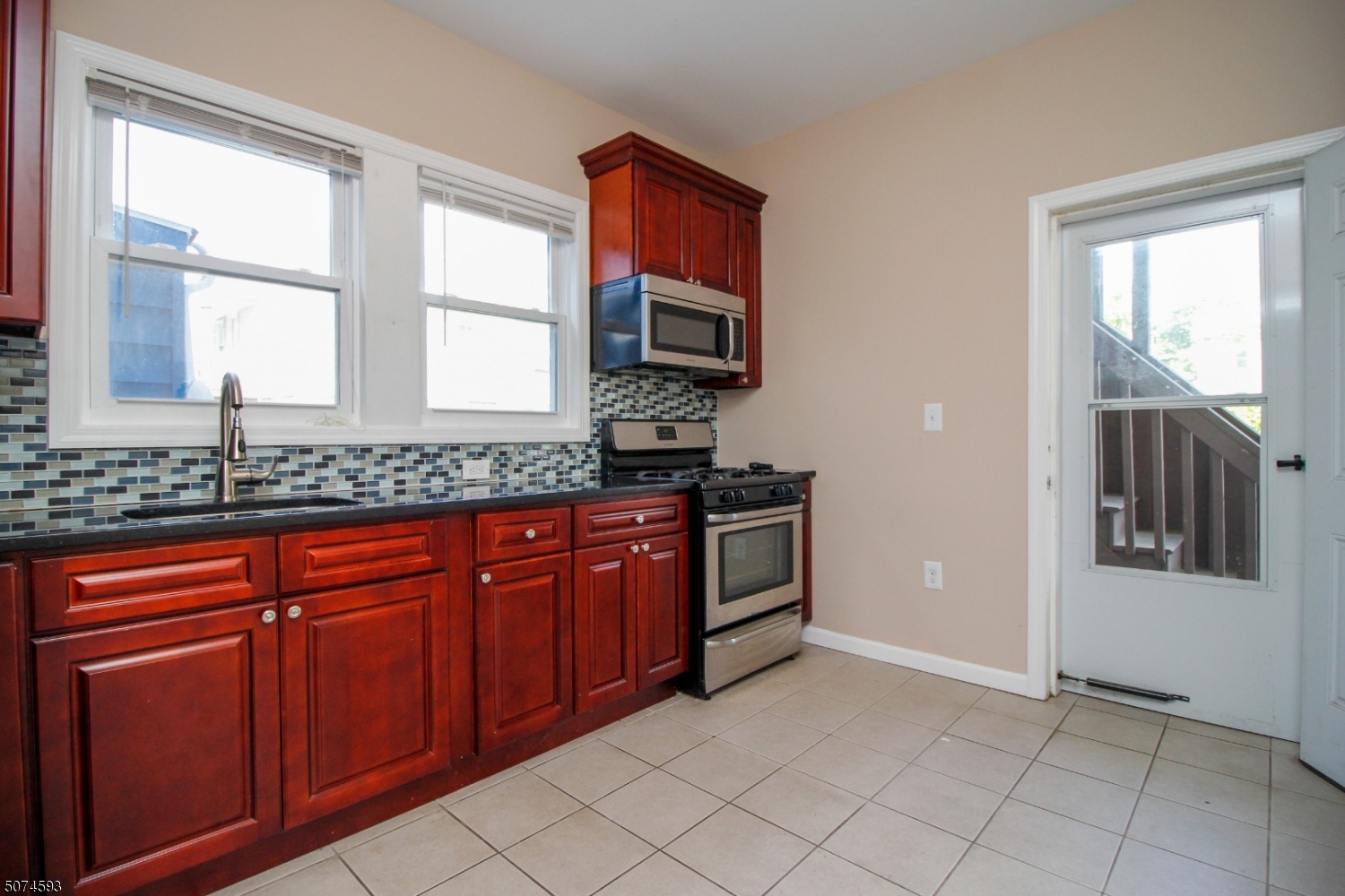 52 New Street, Unit A Montclair, NJ 07042 - Photo 3 of 18 a kitchen with stainless steel appliances granite countertop a stove a sink and a microwave