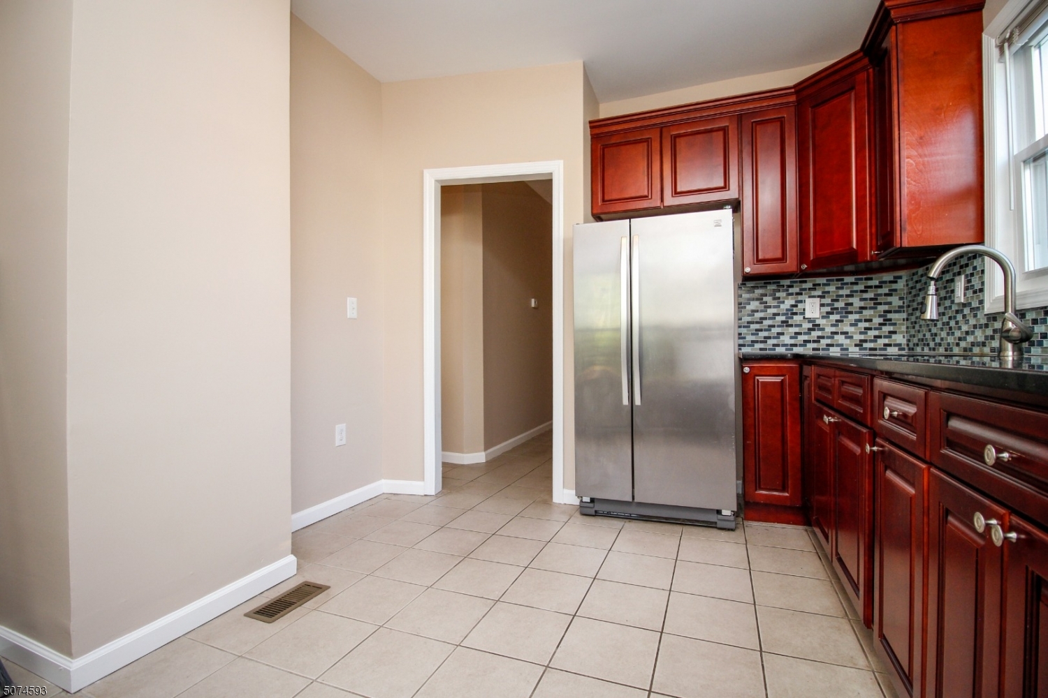 52 New Street, Unit A Montclair, NJ 07042 - Photo 4 of 18 a kitchen with granite countertop a refrigerator and a stove top oven