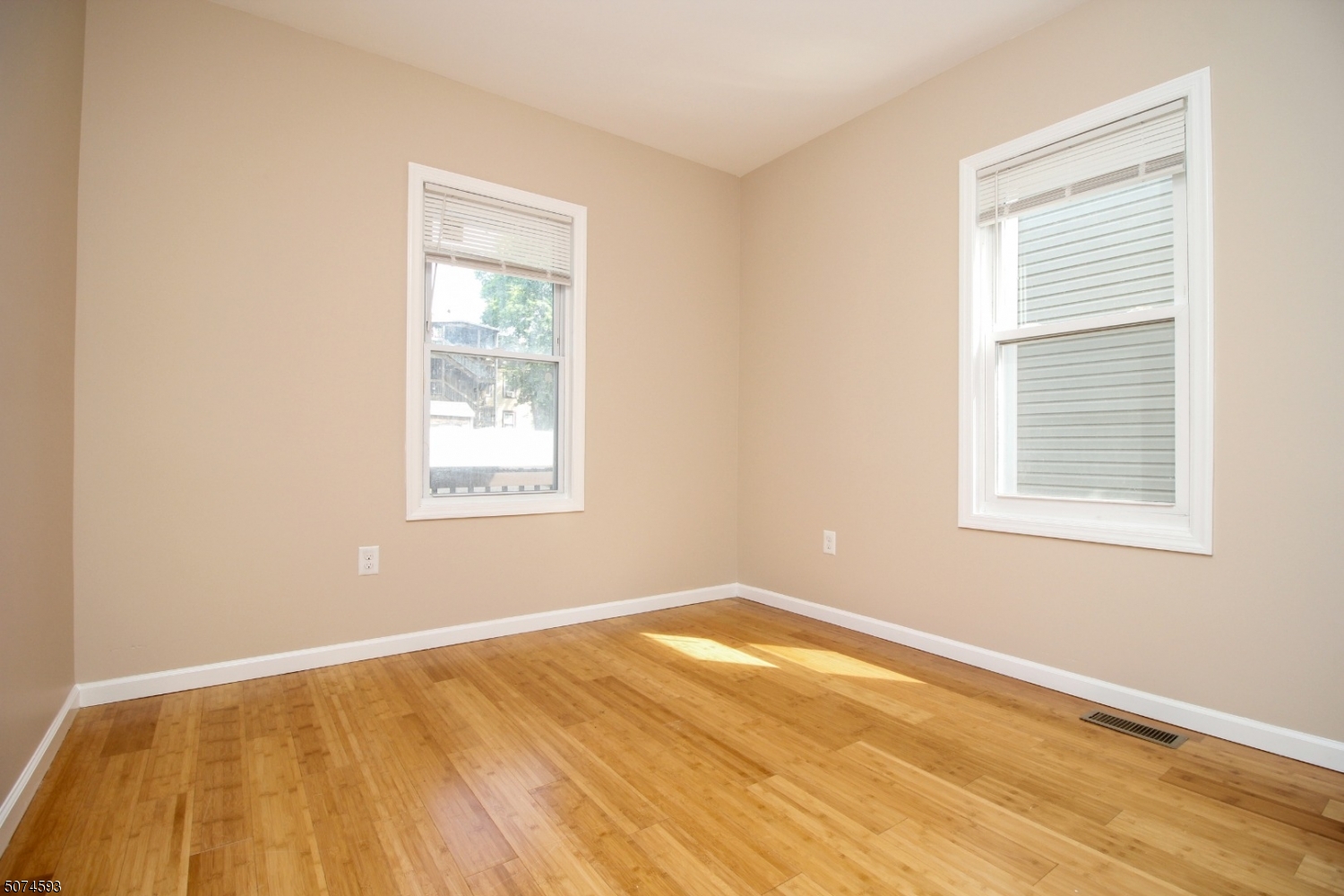 52 New Street, Unit A Montclair, NJ 07042 - Photo 7 of 18 a view of an empty room with wooden floor and a window