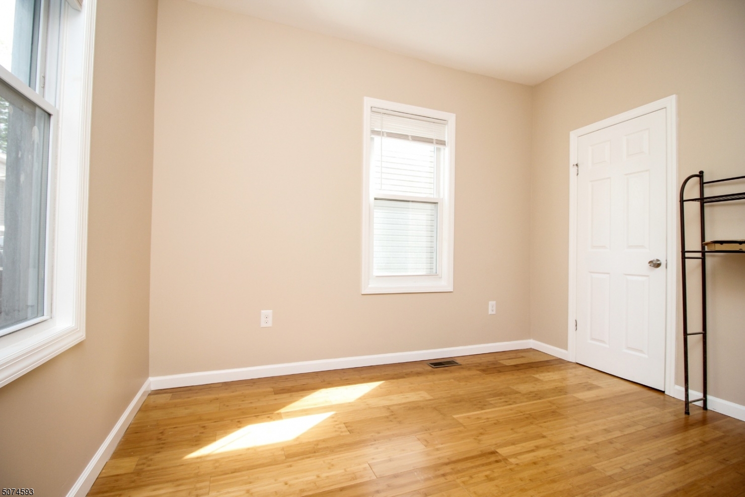 52 New Street, Unit A Montclair, NJ 07042 - Photo 8 of 18 a view of an empty room with wooden floor and a window