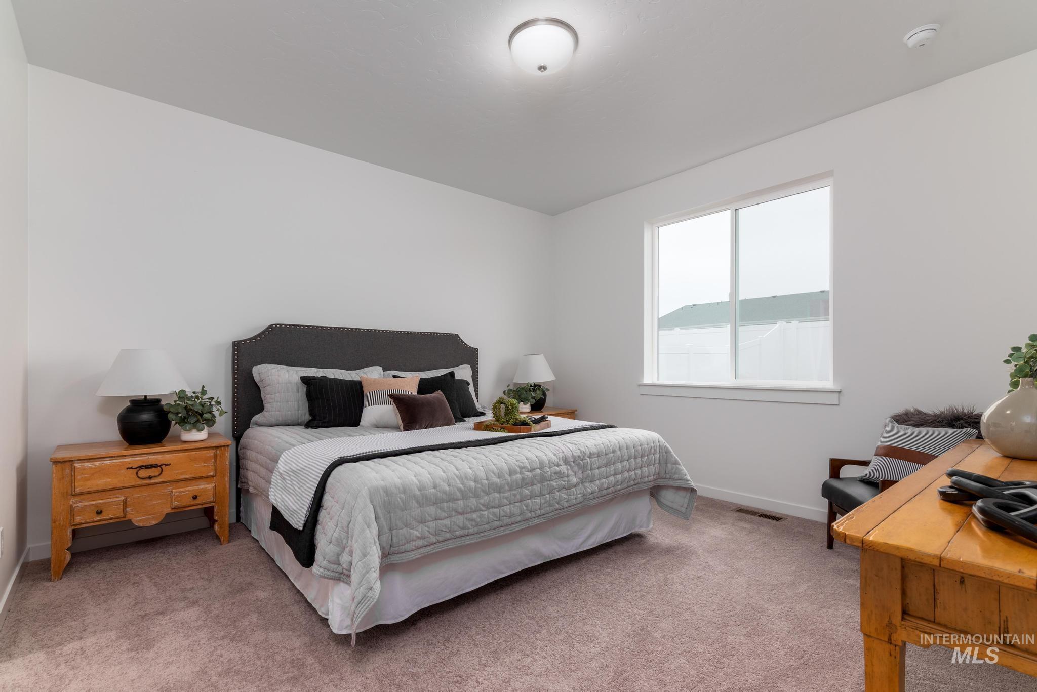 6285 West Snow Currant Street Meridian, ID 83646 - Photo 7 of 26 Open-concept living space featuring wood-finish flooring, recessed lighting, and expansive sliding glass doors