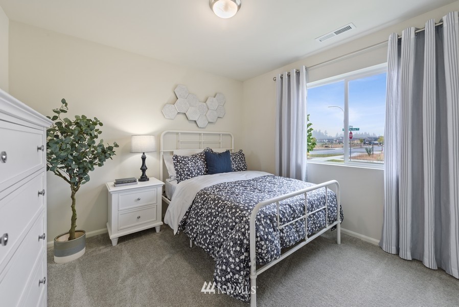 4815 Amherst Way Southwest Port Orchard, WA 98367 - Photo 11 of 12 a bedroom with a bed and a potted plant