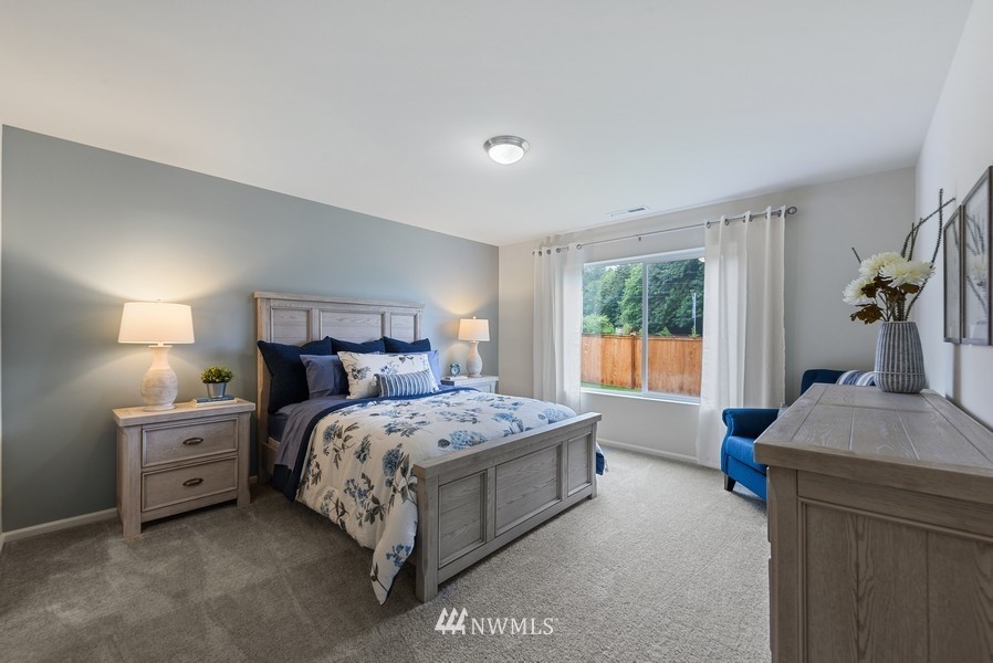 4815 Amherst Way Southwest Port Orchard, WA 98367 - Photo 7 of 12 a bed sitting in a bedroom next to a window