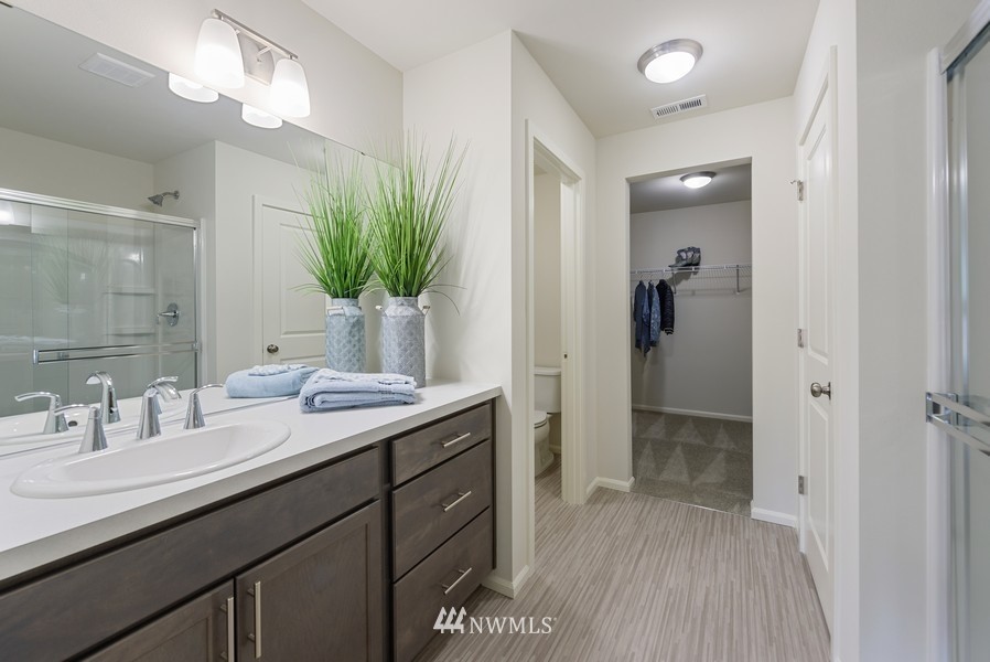 4815 Amherst Way Southwest Port Orchard, WA 98367 - Photo 8 of 12 a bathroom with a granite countertop sink a mirror and a shower