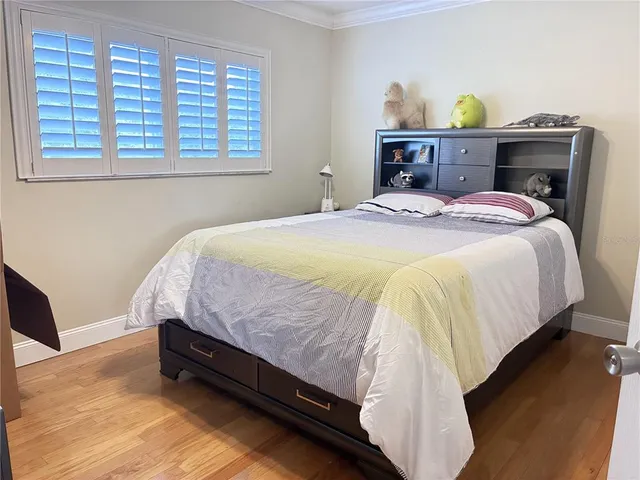 a bed sitting in a bedroom next to a window