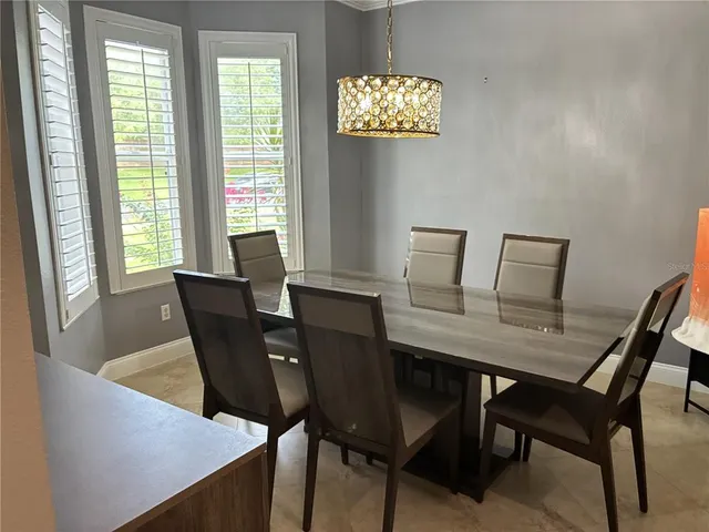 a view of a dining room with furniture and a potted plant