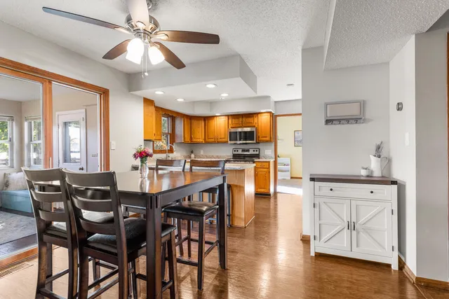 a view of a dining room with furniture and wooden floor